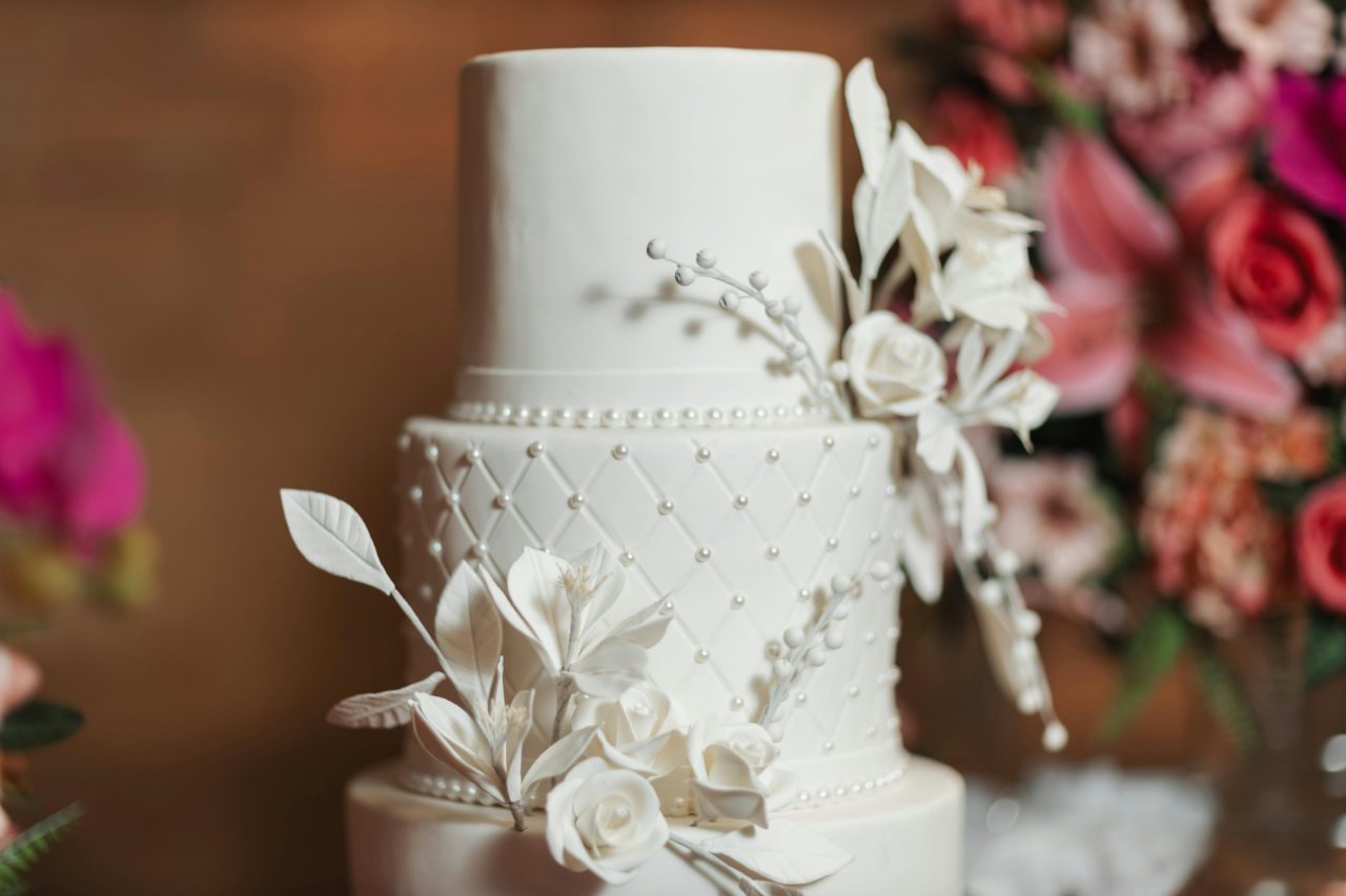 A perfectly smooth white tiered cake