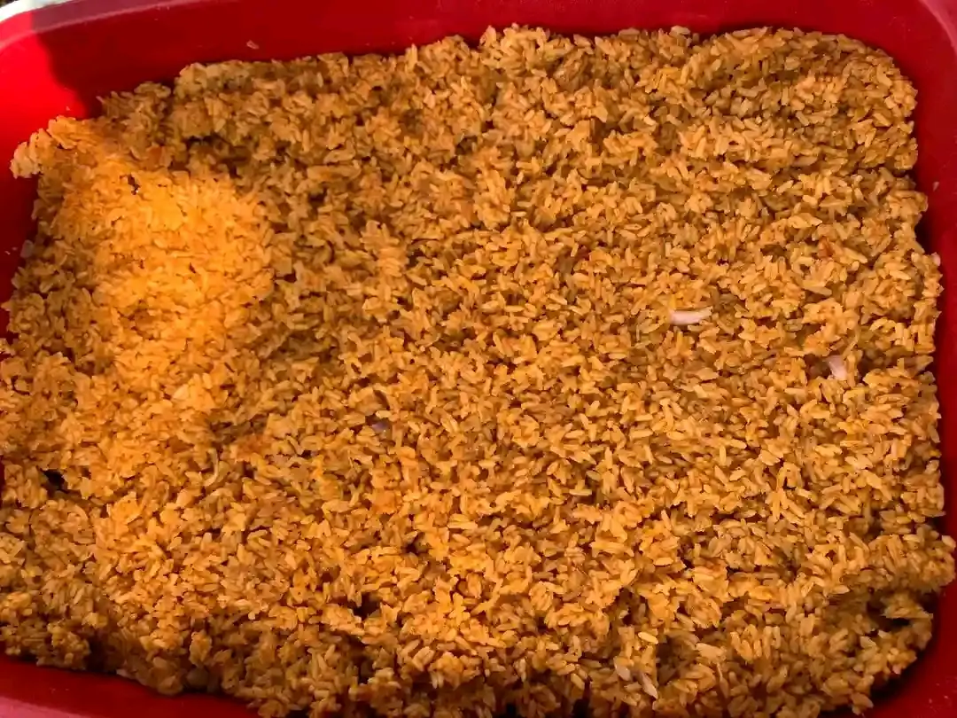 Nigerian jollof rice served with chicken and vegetables
